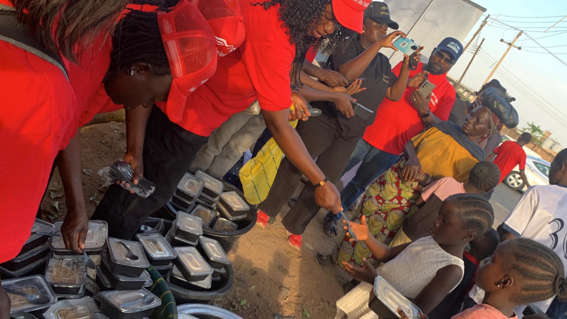 Volunteers distributing packed meals during a street outreach