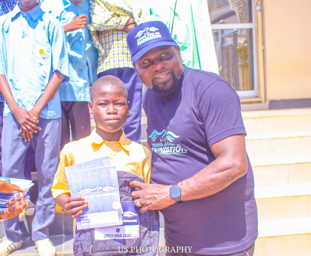 Student receiving a branded JJAF school backpack